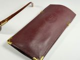 leather glasses case with gold rims and a pair of glasses