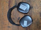 two black headphones that are on a wooden table