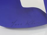 a close up of a blue chair with writing on it