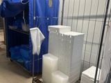 many containers and containers on the floor in a room