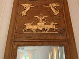 a mirror that has a picture of a man and animals on it