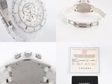 two watches and a card on a white table