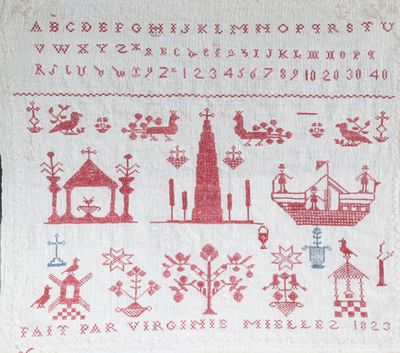 une broderie au point de croix rouge et blanche représentant une ville