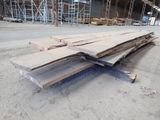 several pieces of wood are stacked on top of each other in a warehouse
