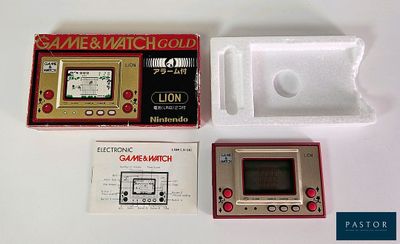 a game and watch set in a box on a table