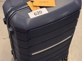 a suitcase with a tag on it sitting on the floor
