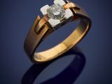 a gold and diamond ring with a single stone in the center
