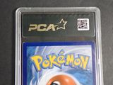 a pokemon card in a plastic case on a table