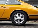 a close up of a yellow car parked in front of a building