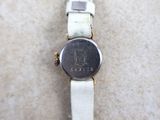 a close up of a watch on a white surface