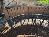 a wooden bench sitting in the middle of a garden