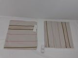two towels on a bed with a price tag on it