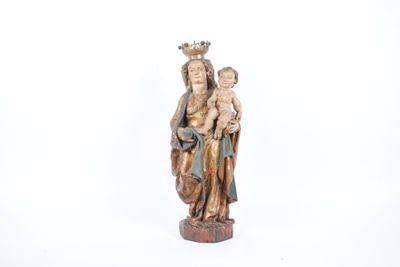 an old statue of a woman holding a child in her arms