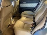 the back seats of a car with the door open in a car showroom
