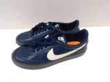 blue and white nike sneakers with orange soles on a white surface