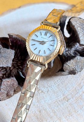 a watch that is laying on a piece of cloth