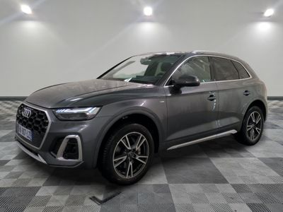 a grey audi qx parked on a checkered tile floor