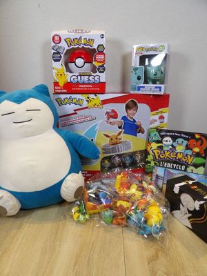 a stuffed animal sitting on a table next to a bunch of toys