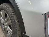 a close up of a car ' s front bumper with a hole in the bumper