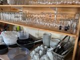 many dishes and glasses on the shelves in the kitchen