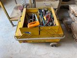 a yellow box with tools in it sitting on the floor