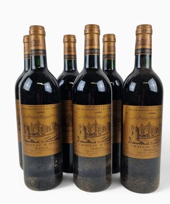 four bottles of wine are lined up on a white surface