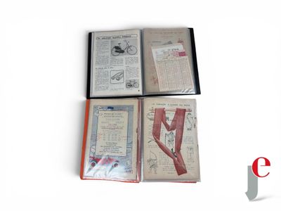 several books are lined up on a white surface with a red bookmark