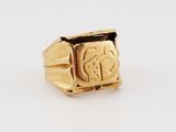 a gold signet ring with an image of a man ' s face