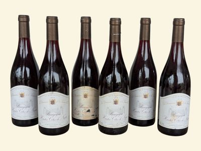 six bottles of wine are lined up in a row on a table