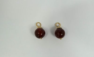 a pair of red glass beads on a white background