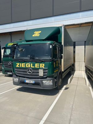 two trucks that are parked in a parking lot