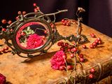a mirror on top of a book with flowers on it