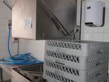 an image of a commercial kitchen with a sink and a dishwasher