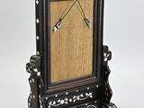 a black and white clock with a wooden frame on it