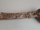 a wooden handle with carvings on it on a table