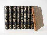 six books are lined up in a row on a white surface