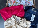 a box full of clothes that is sitting on the floor