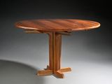 an image of a round table with a wooden base and a wooden top