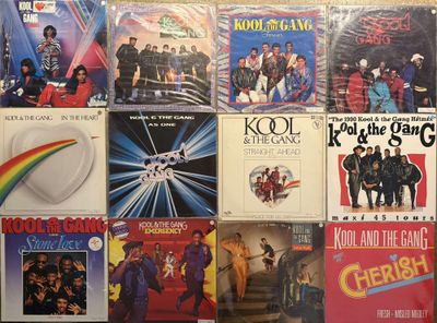 many different album covers on the wall of a room