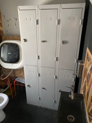 a bathroom with a toilet and lockers next to each other