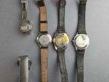 five different watches and a lighter on the table