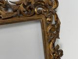 a picture of a gold mirror hanging on a wall