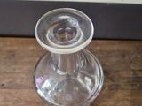 a clear glass vase sitting on a wooden table