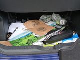 a car trunk filled with various items in the trunk