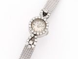 a close up of a watch on a white surface with a white background