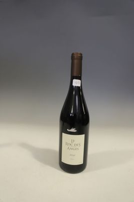 a bottle of wine sitting on top of a table next to a bottle of wine