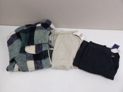 three pieces of clothing on a white table