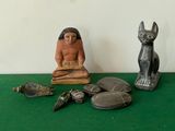 a small statue of a cat and other items on a table