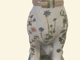 a dog statue sitting on top of a green table