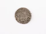 a close up of a silver coin on a white surface